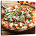 Prosciutto Pizza auf Holztisch Leinwandbild Quadratisch