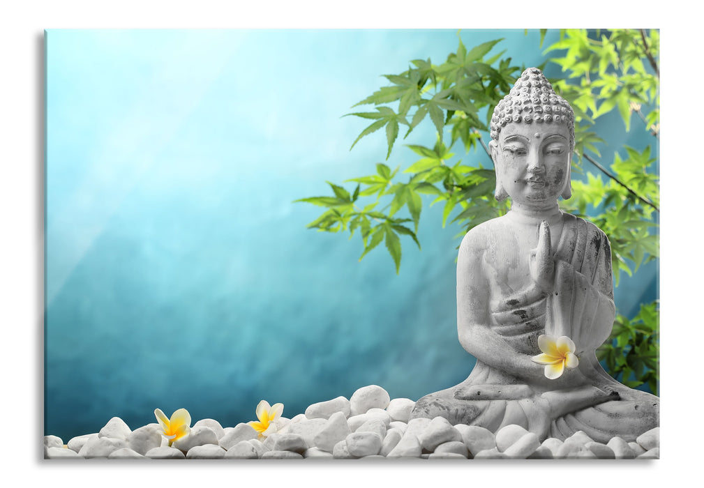 Buddha auf Steinen mit Monoi Blüte, Glasbild