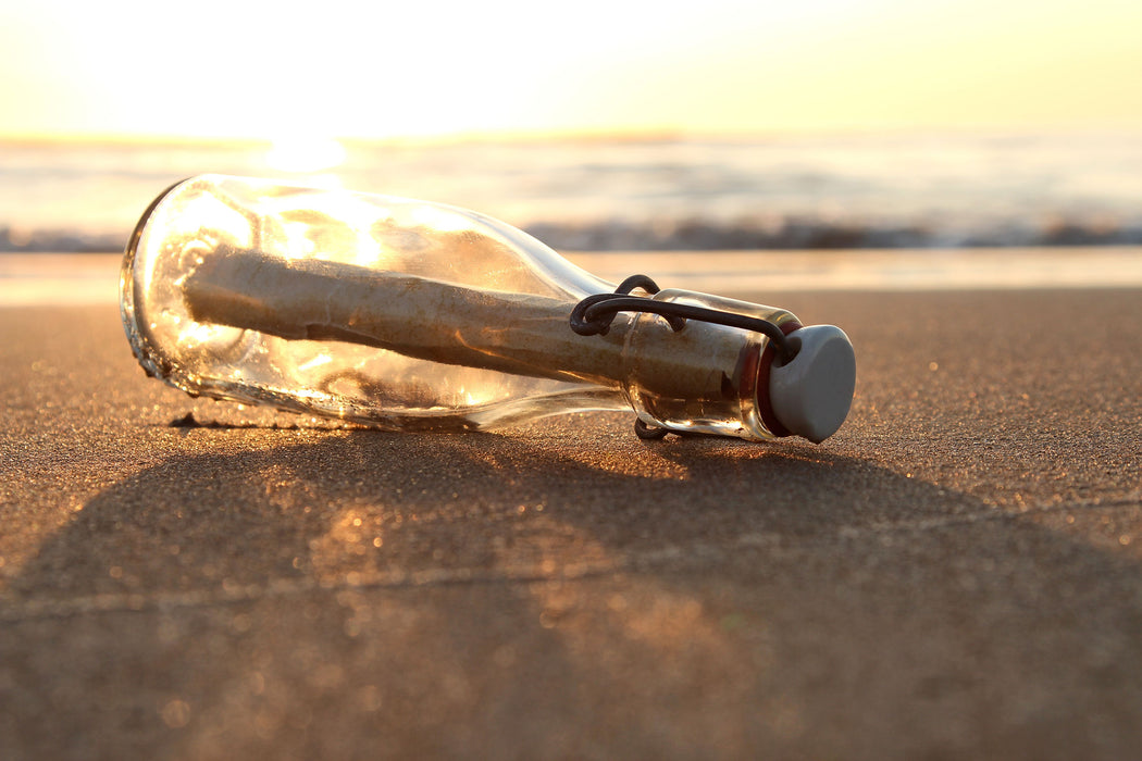 Flaschenpost am Strand, Glasbild