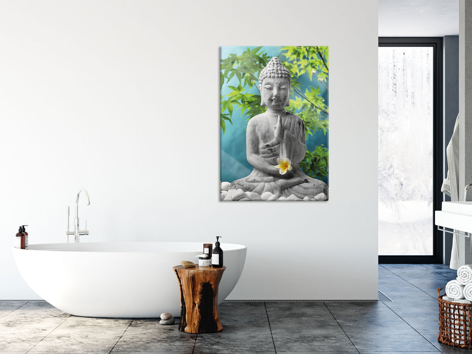 Buddha auf Steinen mit Monoi Blüte, Glasbild