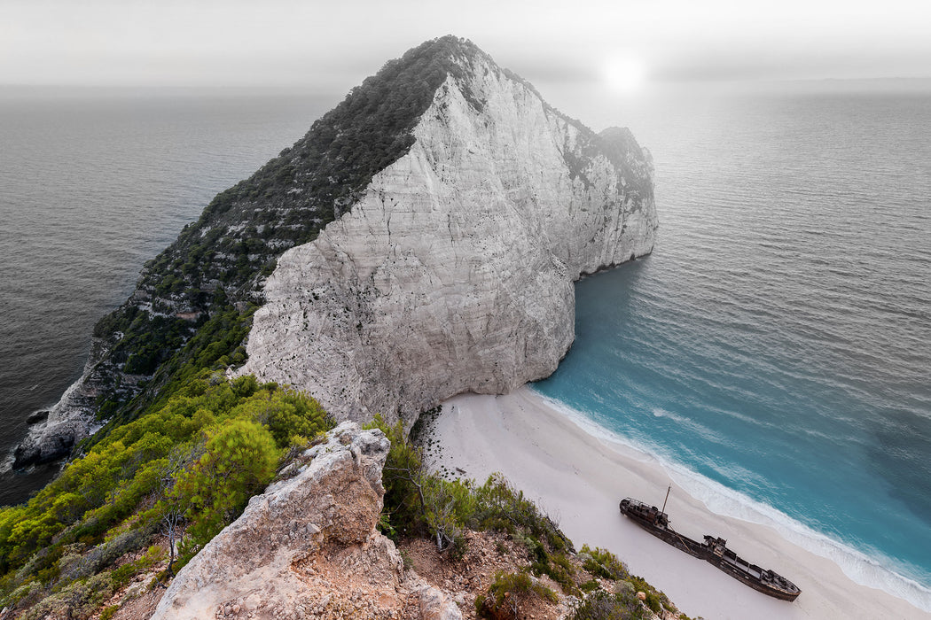 Nagio Strand im Sonnenuntergang, Glasbild