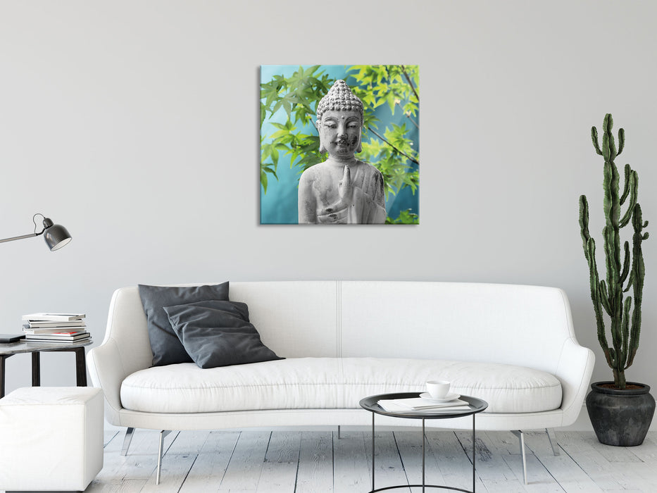 Buddha auf Steinen mit Monoi Blüte, Glasbild Quadratisch