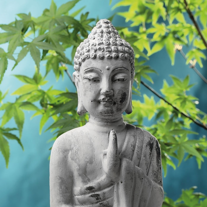 Buddha auf Steinen mit Monoi Blüte, Glasbild Quadratisch