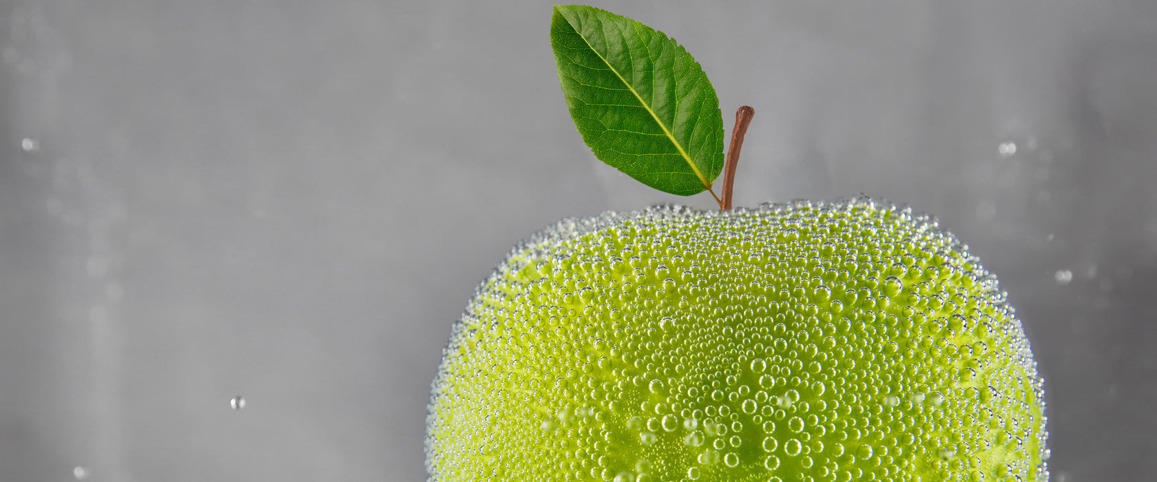 Grüner leckerer Apfel im Wasser, Glasbild Panorama