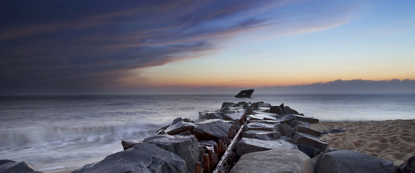 Steinlinie im Meer, Glasbild Panorama