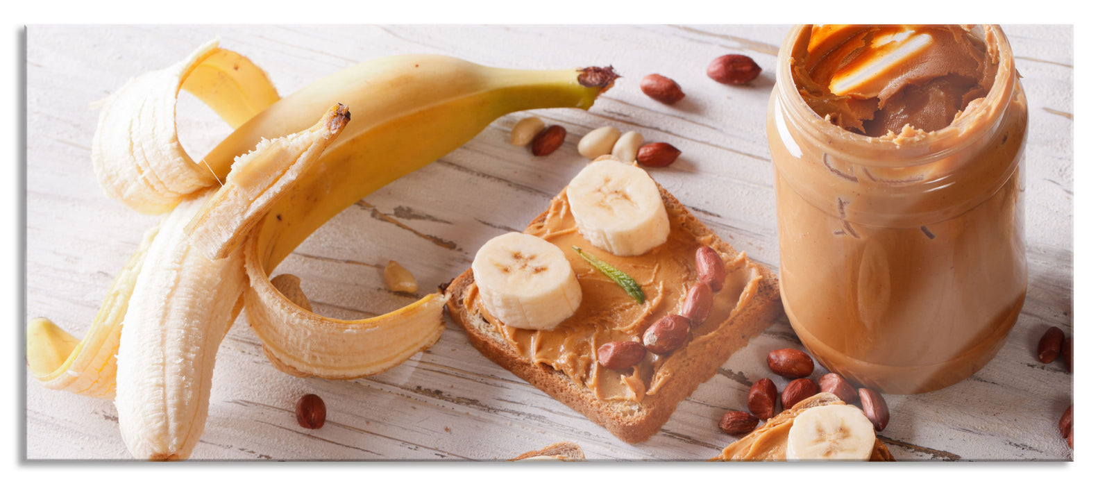 Pixxprint Erdnussbutter Bananen Sandwich, Glasbild Panorama