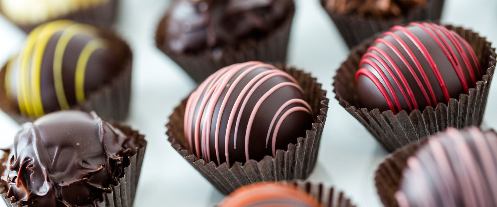 Süße Pralinen, Glasbild Panorama