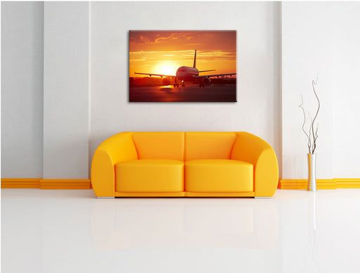 Flugzeug im Sonnenuntergang Leinwandbild über Sofa