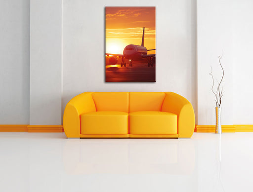 Flugzeug im Sonnenuntergang Leinwandbild über Sofa