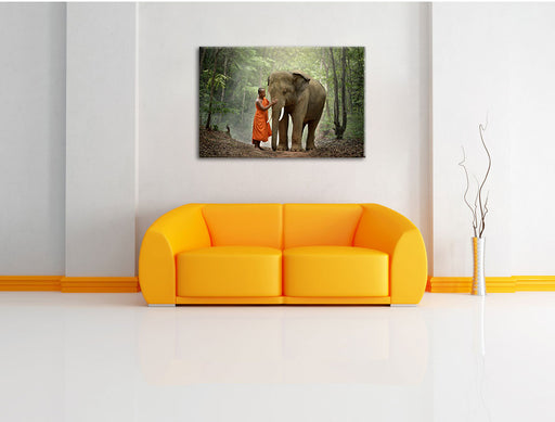 wunderschöner Elefant mit Mönch Leinwandbild über Sofa