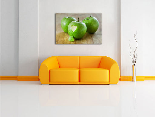 ein Herzchen im Apfel Leinwandbild über Sofa