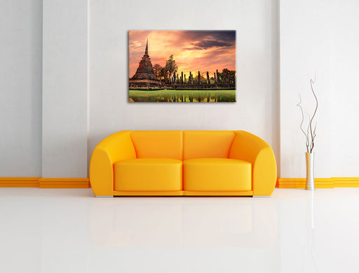 Buddha Tempel im Sonnenuntergang Leinwandbild über Sofa