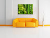 Bambus mit Blätern Leinwandbild über Sofa