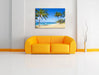 Wunderschöner Strand mit Palmen Leinwandbild über Sofa