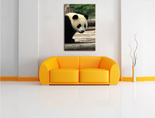 Panda auf Holzstämmen Leinwandbild über Sofa