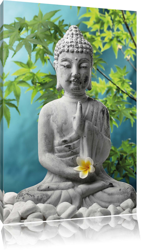 Buddha auf Steinen mit Monoi Blüte Leinwandbild