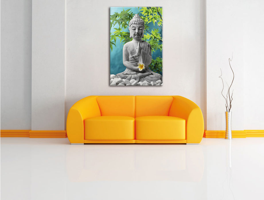 Buddha auf Steinen mit Monoi Blüte Leinwandbild über Sofa