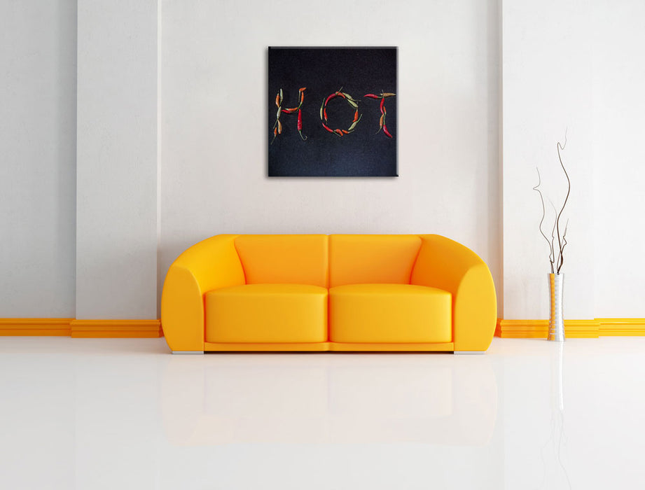 Chilis zu dem Wort Hot geformt Leinwandbild Quadratisch über Sofa