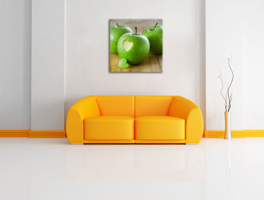 ein Herzchen im Apfel Leinwandbild Quadratisch über Sofa