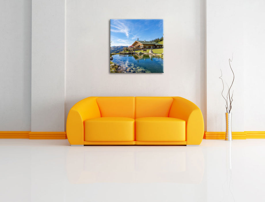 Schönes Haus in den Alpen Leinwandbild Quadratisch über Sofa
