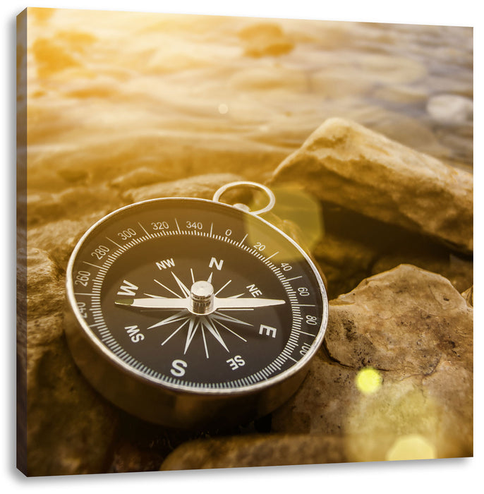 Kompass auf Steinen Reiselust Leinwandbild Quadratisch