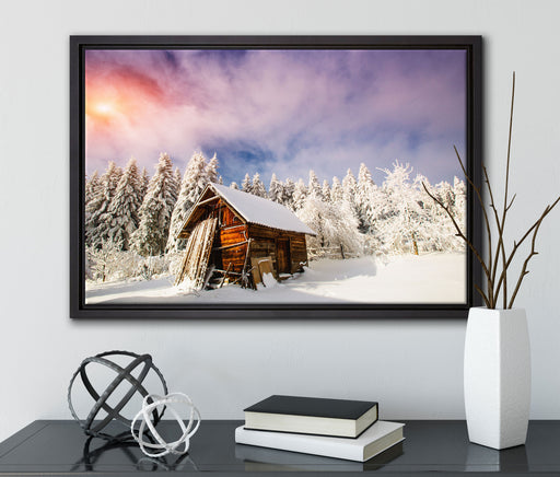 Holzhütte im Schnee auf Leinwandbild gerahmt mit Kirschblüten