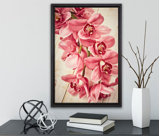 Rosane Orchideenblüten auf Leinwandbild gerahmt mit Kirschblüten