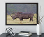 großes Nashorn in der Savanne auf Leinwandbild gerahmt mit Kirschblüten