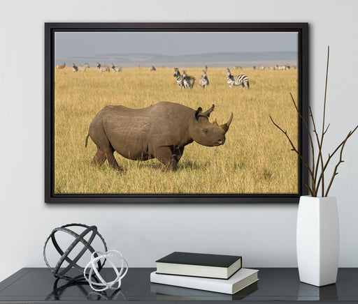 großes Nashorn mit Zebrahorde auf Leinwandbild gerahmt mit Kirschblüten