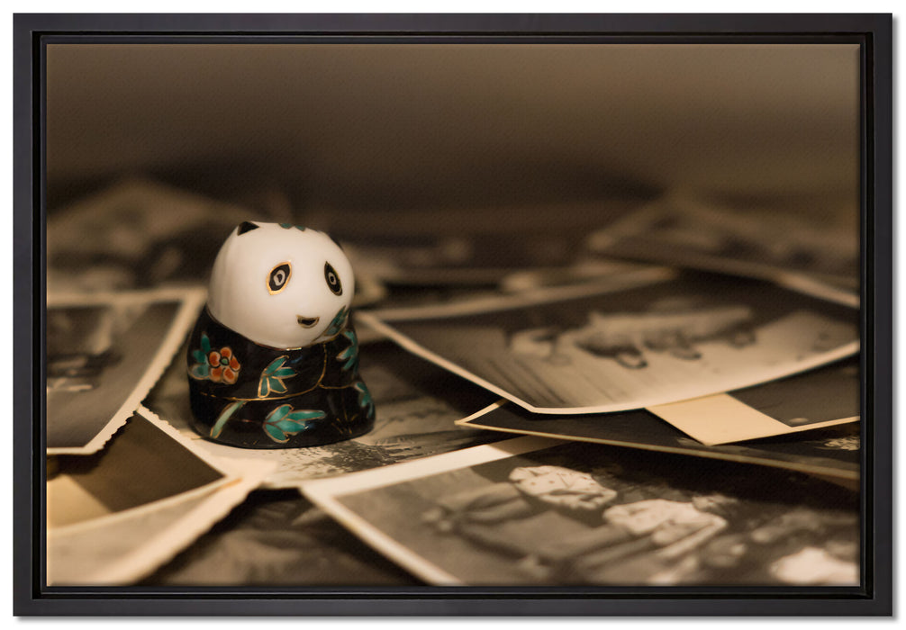 Panda Figur zwischen Fotografien auf Leinwandbild gerahmt Größe 60x40