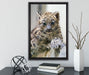 Leopardenjunges beim Klettern auf Leinwandbild gerahmt mit Kirschblüten