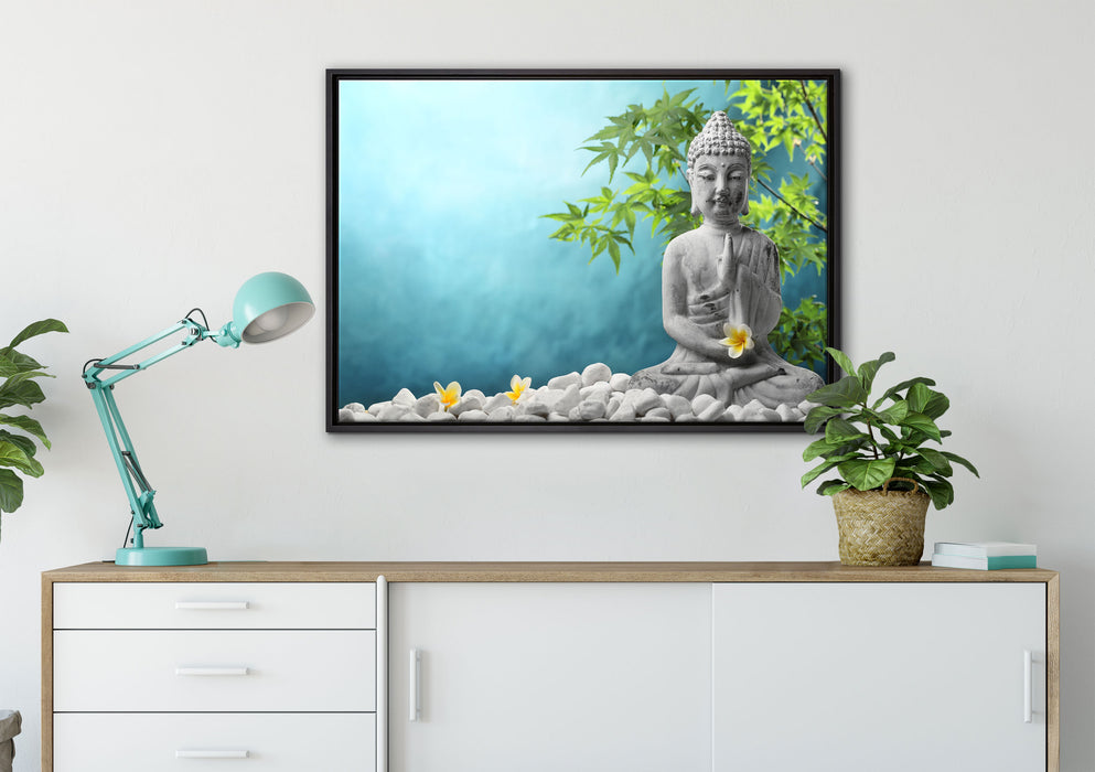 Buddha auf Steinen mit Monoi Blüte auf Leinwandbild gerahmt verschiedene Größen im Wohnzimmer