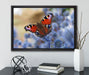 Schöner Schmetterling Pfauenauge auf Leinwandbild gerahmt mit Kirschblüten