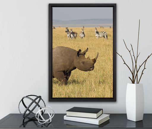 großes Nashorn mit Zebrahorde auf Leinwandbild gerahmt mit Kirschblüten