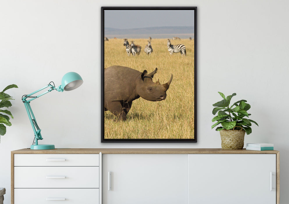 großes Nashorn mit Zebrahorde auf Leinwandbild gerahmt verschiedene Größen im Wohnzimmer