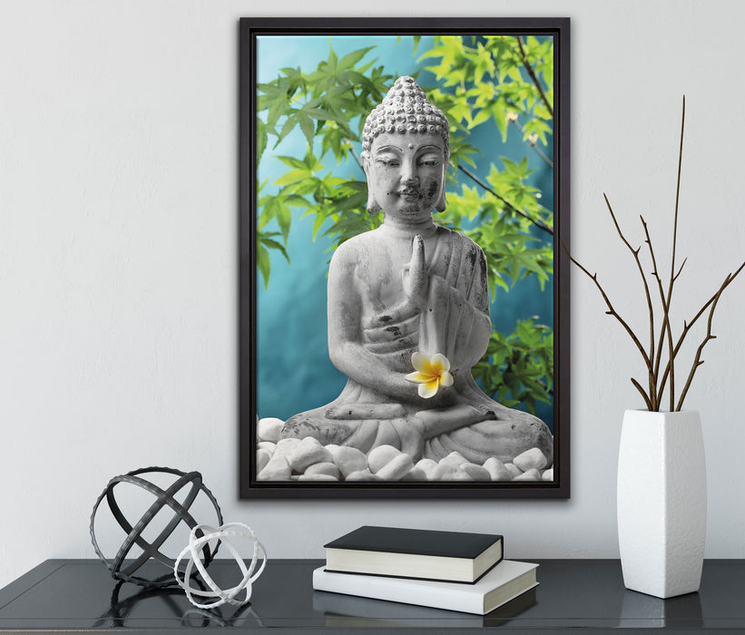 Buddha auf Steinen mit Monoi Blüte auf Leinwandbild gerahmt mit Kirschblüten