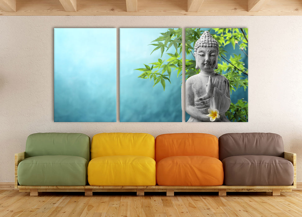 Buddha auf Steinen mit Monoi Blüte, XXL Leinwandbild als 3 Teiler